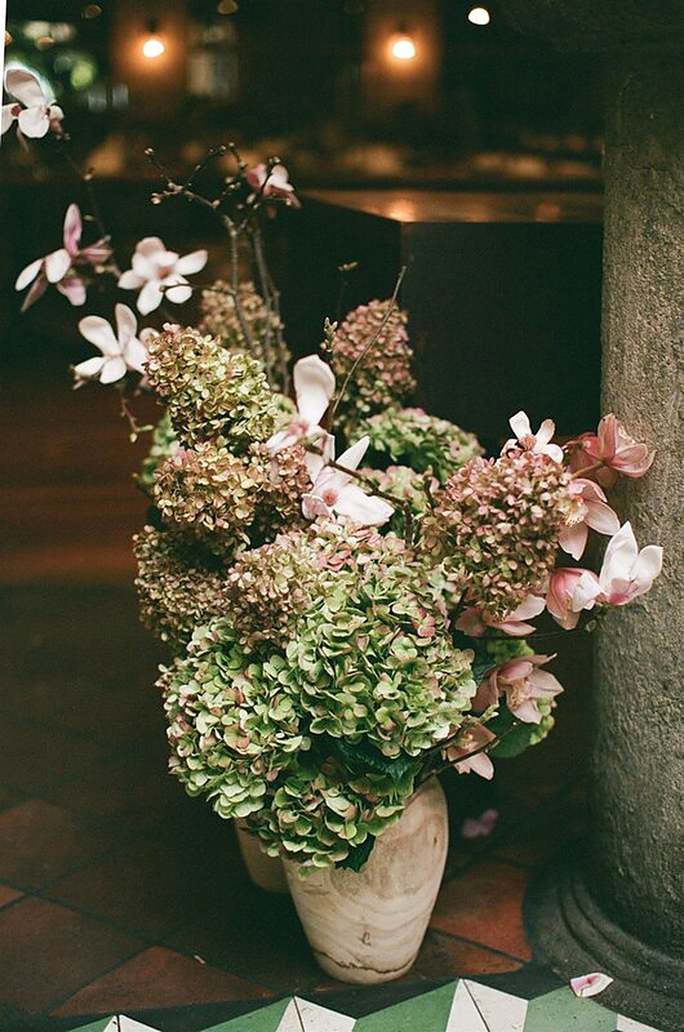 Earthy floral style — textural blooms in a stone vessel